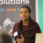 Agnes Mukumba presenting at a conference.